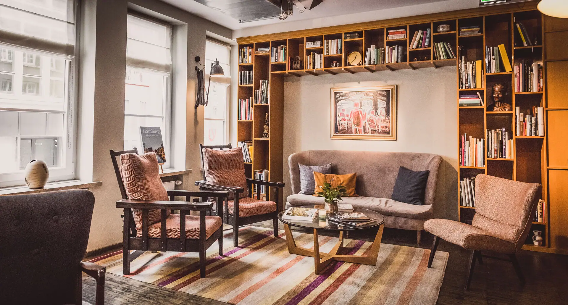 Loungebereich im HENRI Hamburg mit einer Couch und Stühlen.